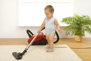 baby boy vacuuming carpet